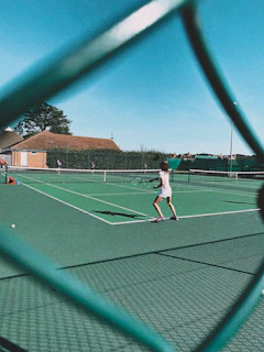 woman playing tennis on court