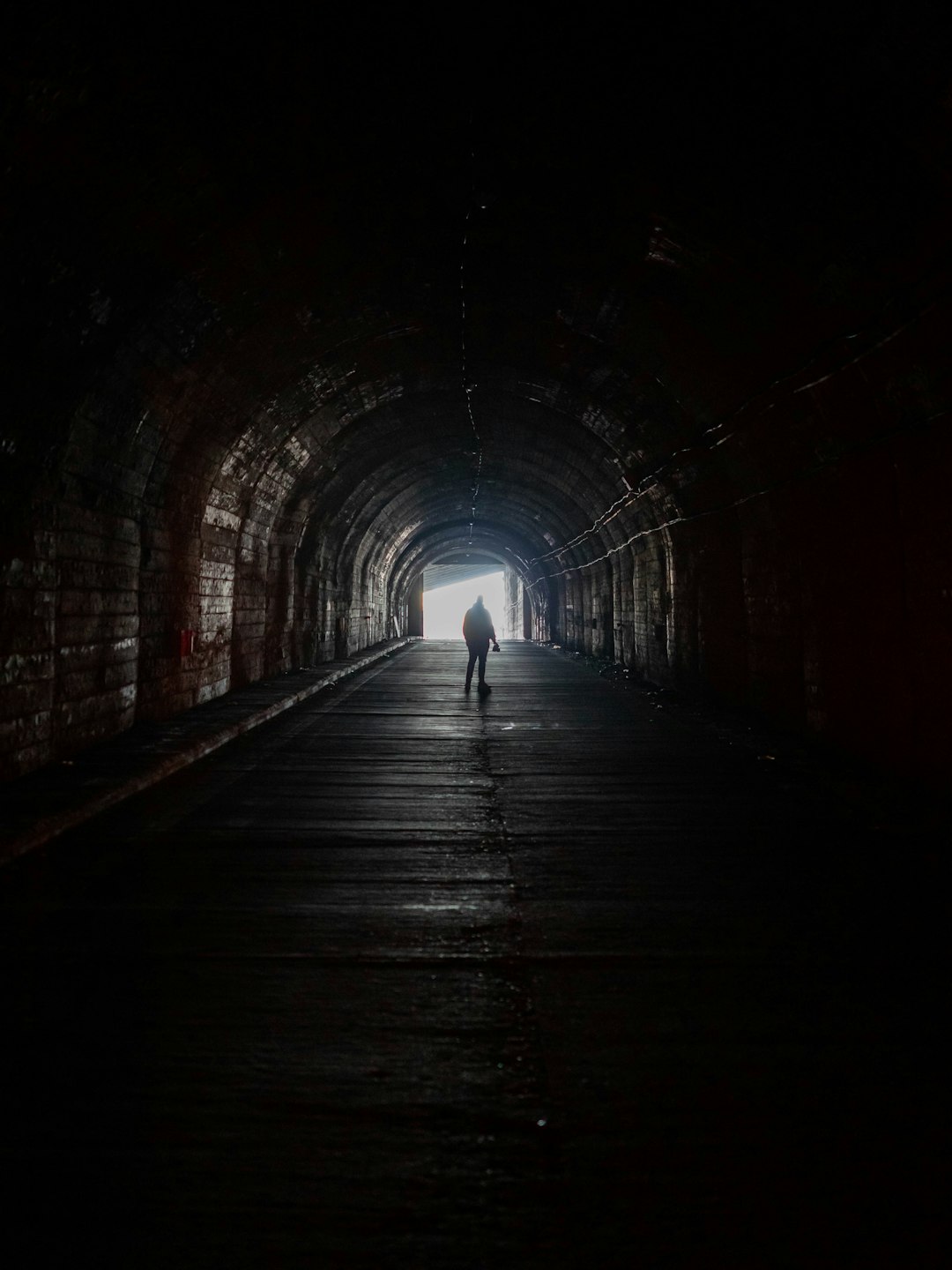 woman walking on tunnel