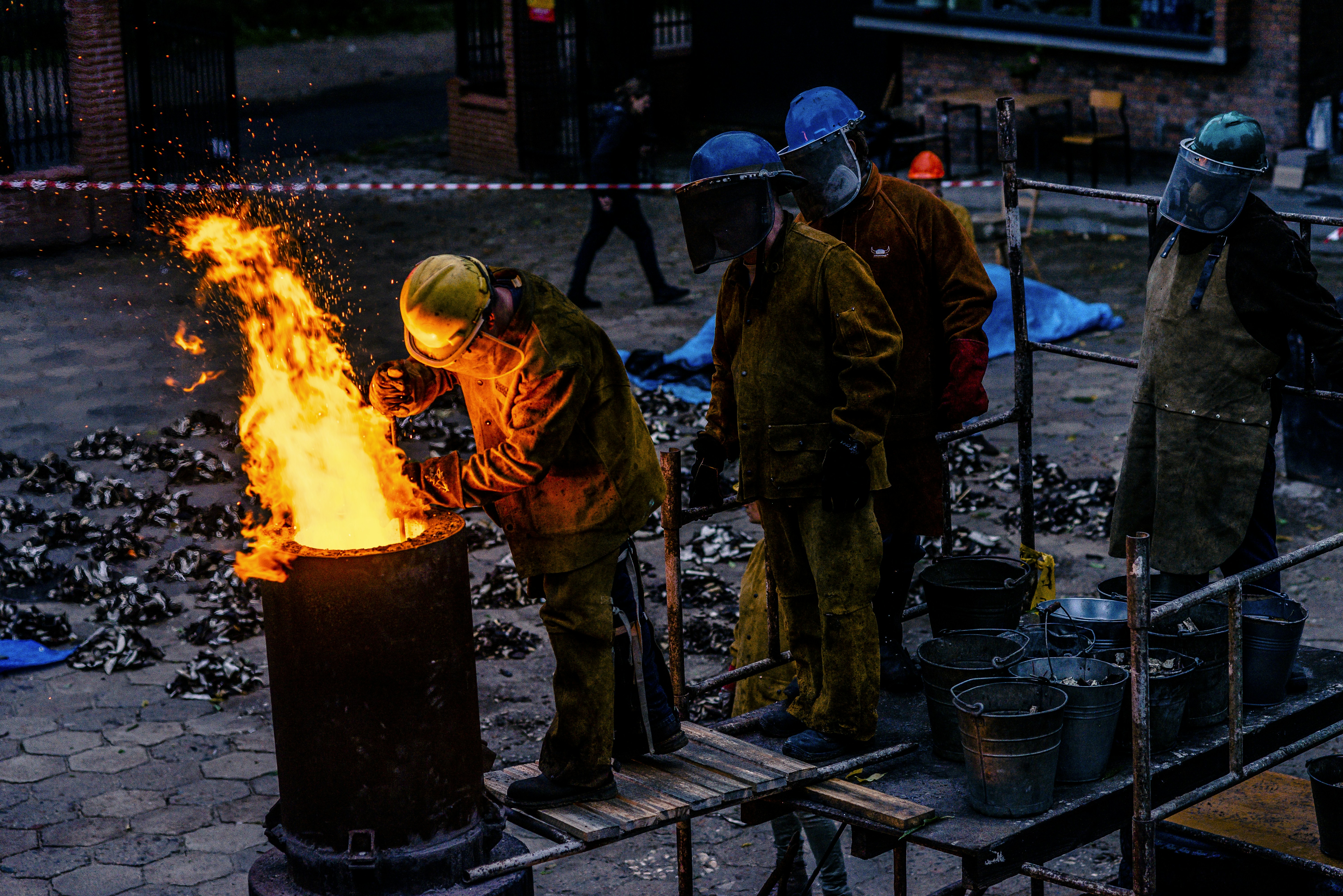 group of man lining in front of can with fire
