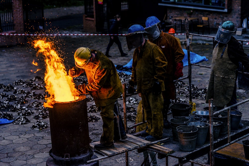 group of man lining in front of can with fire