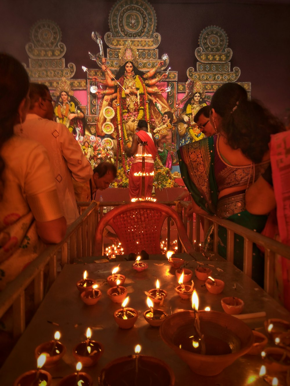 people walking towards Hindu Deity statue