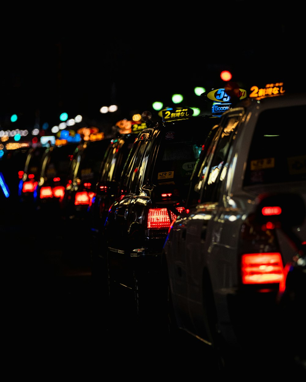 selective focus photo of row of vehicles