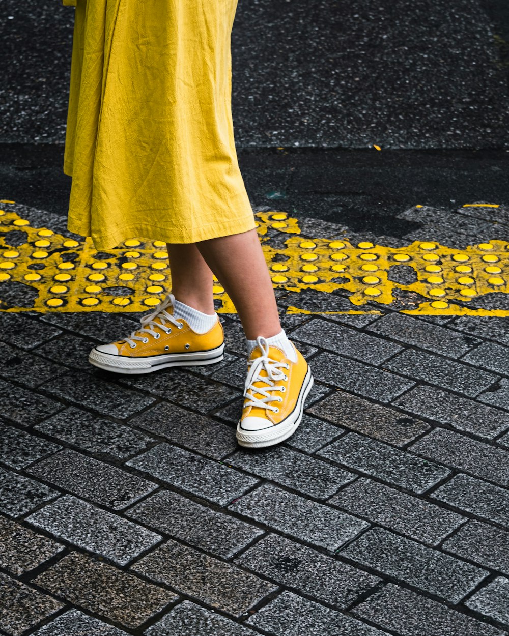 person wearing yellow maxi dress and yellow Converse low-top sneaker