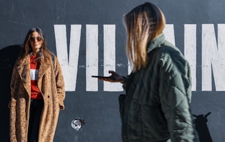 woman leaning on the black wall