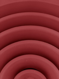 a close up of a red object with many circles