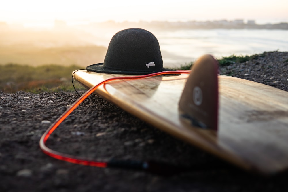 selective focus photo of black hat on brown boat