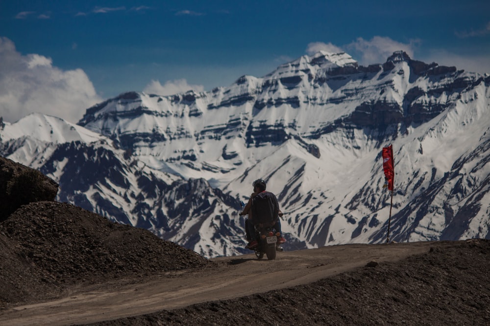 person riding motorcycle on brown sand pathway