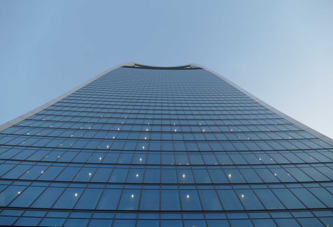 low-angle photography of blue high-rise building