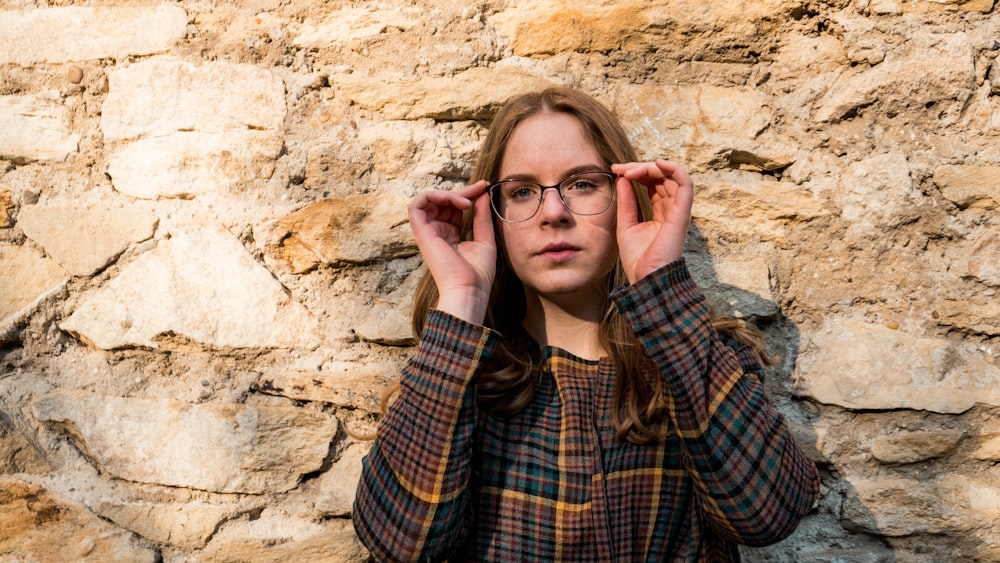 woman wearing brown and yellow plaid trench coat