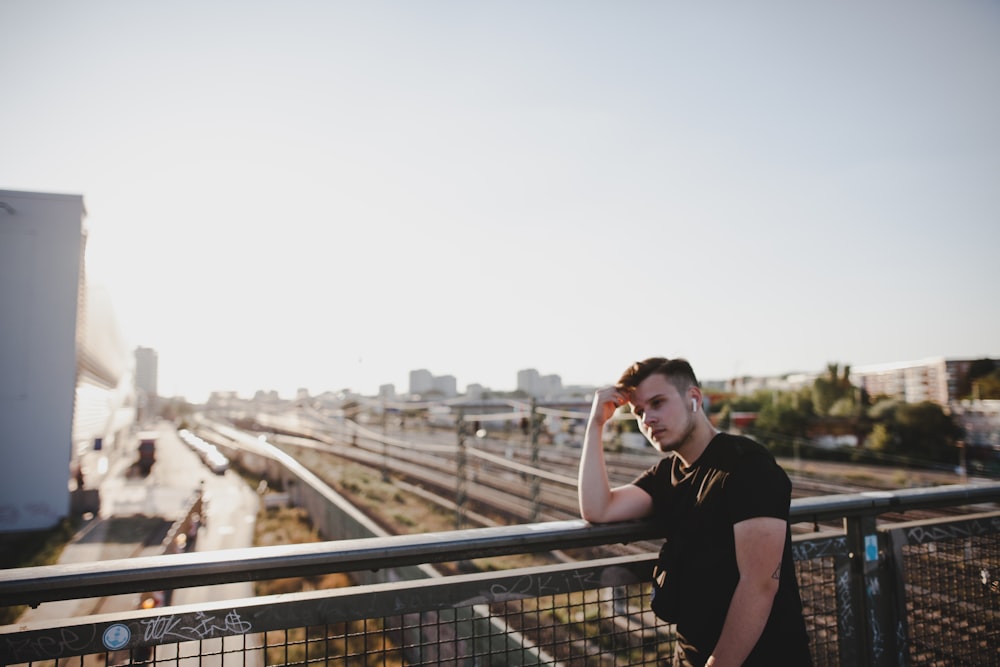 man wearing black crew-neck t-shirt