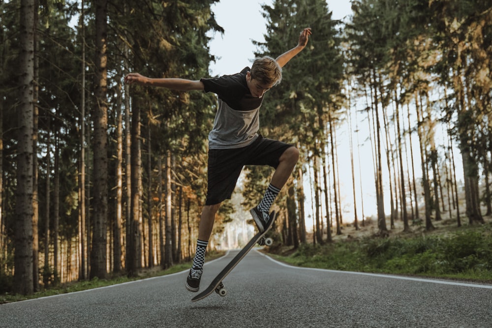man doing a skateboard trick on paved road