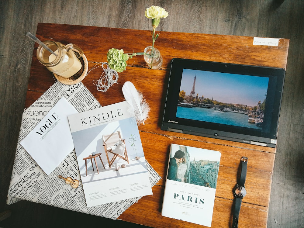 Kindle book on brown wooden table