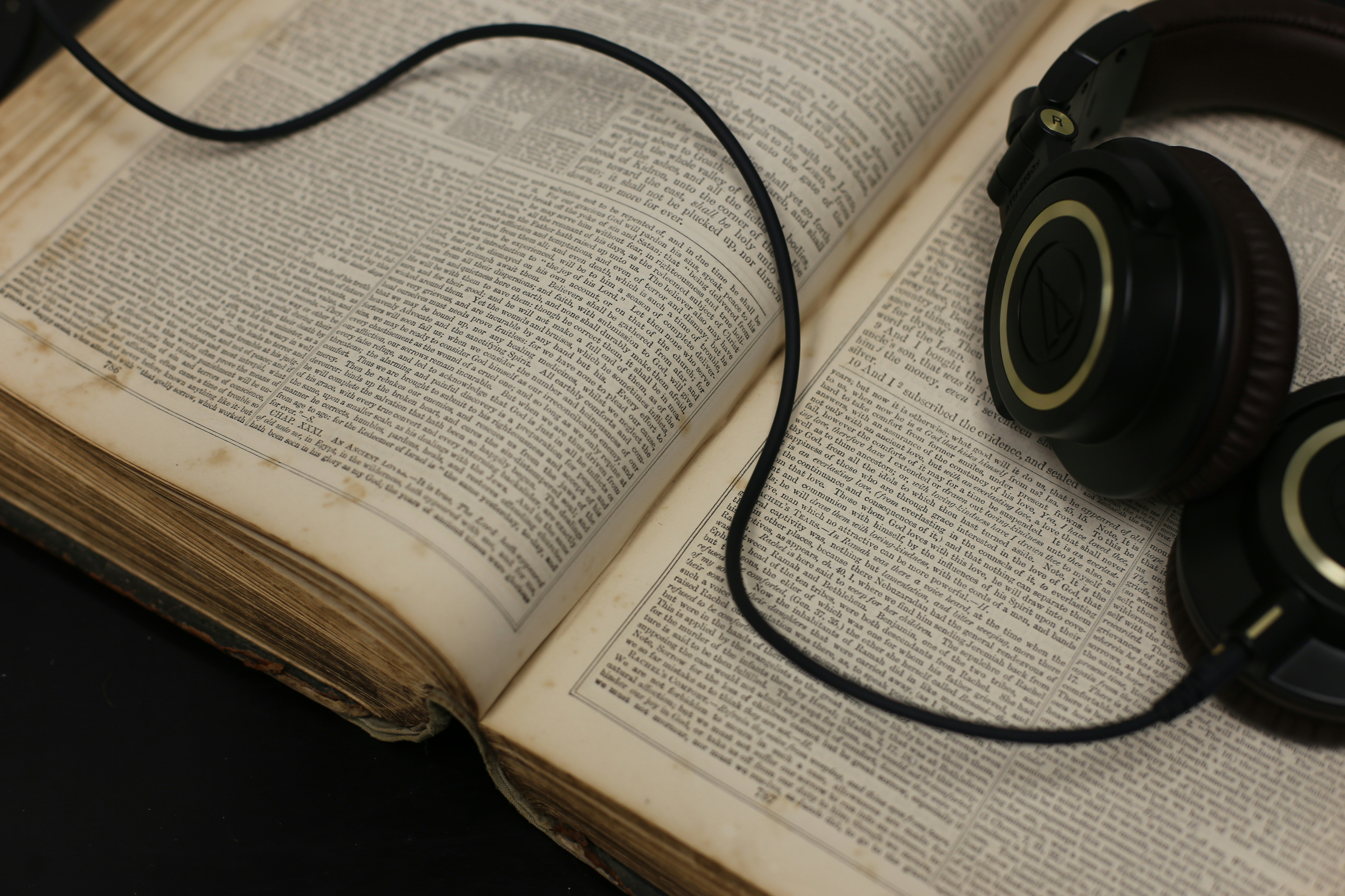 black corded headset on open book
