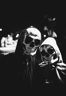 grayscale photo of two person wearing masks