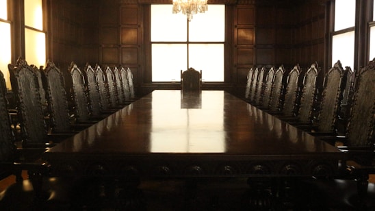 rectangular brown wooden table with chairs