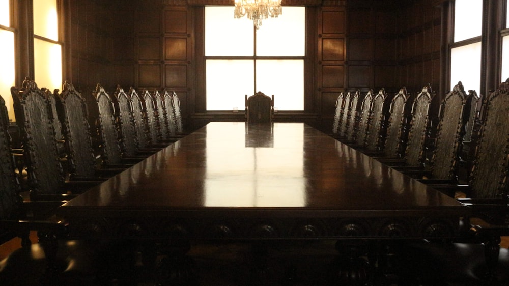 rectangular brown wooden table with chairs