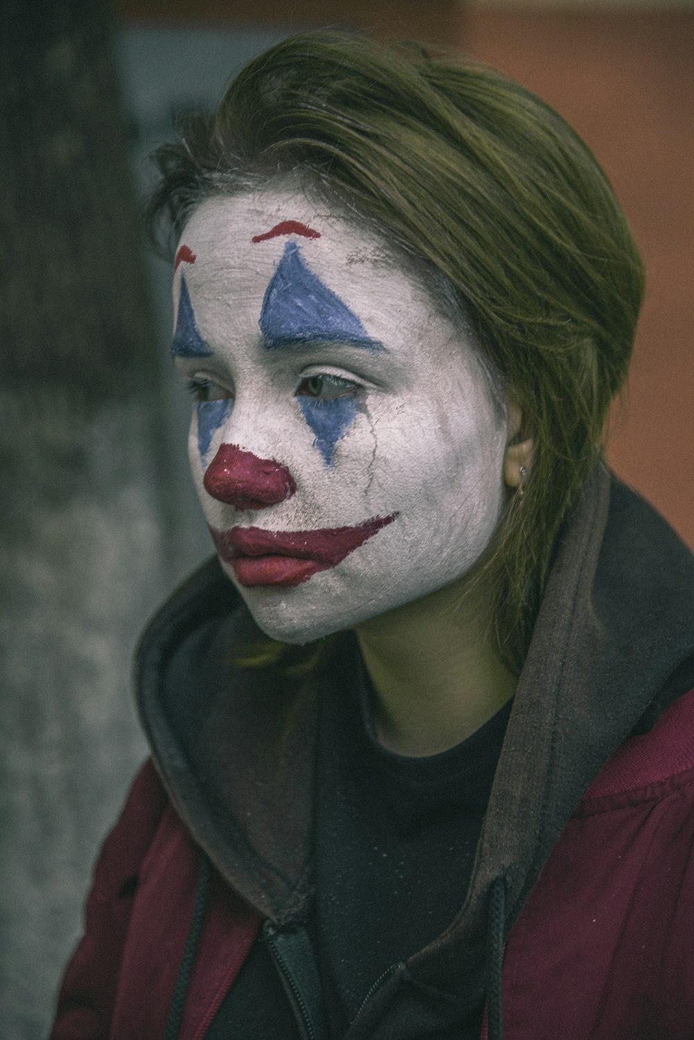woman wearing The Joker mask