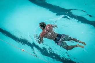 man swimming in pool
