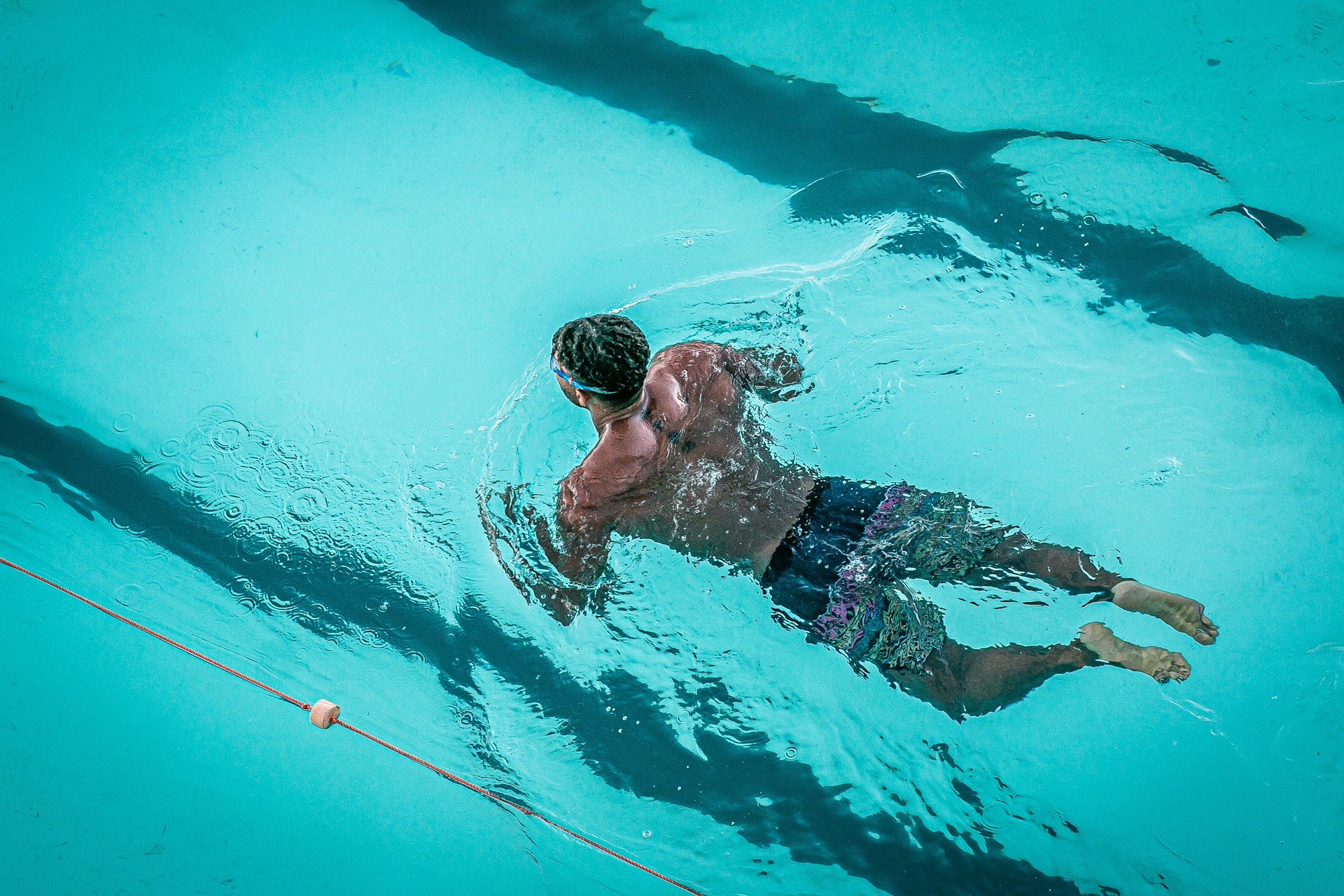 man swimming in pool