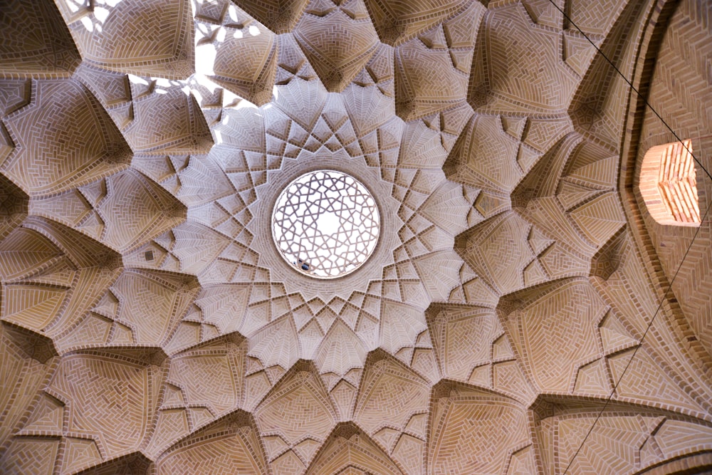 the ceiling of a building with a circular window