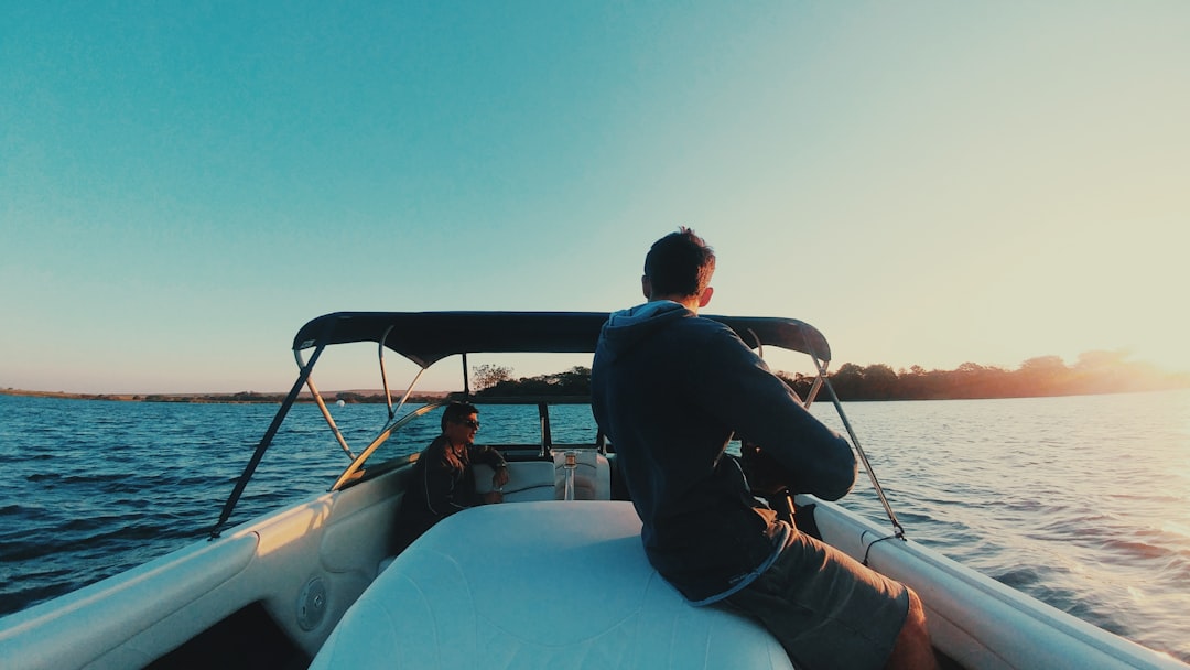 man riding on powerboat under clear blue sky