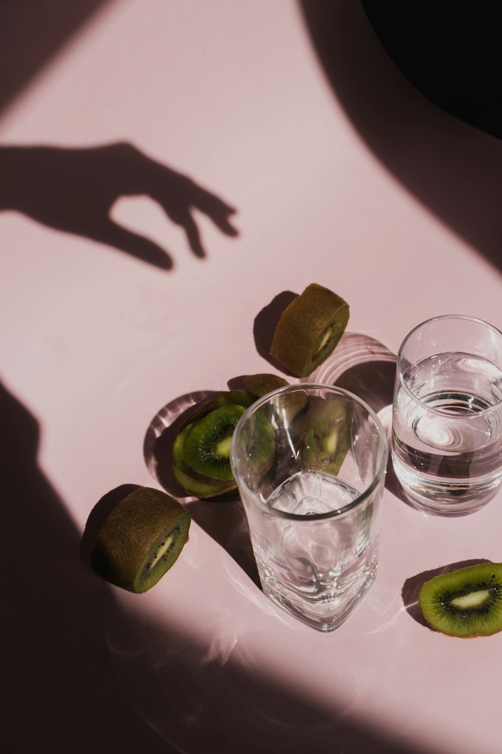 two clear drinking glasses with kiwi fruits