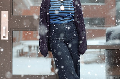 woman in black denim jeans blizzard teams background