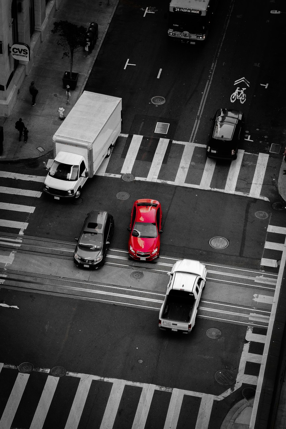 selective color photography of red vehicle on paved road