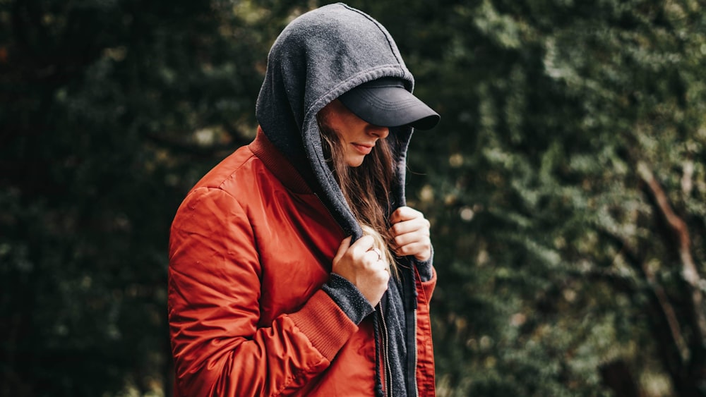 woman wearing red and grey jacket