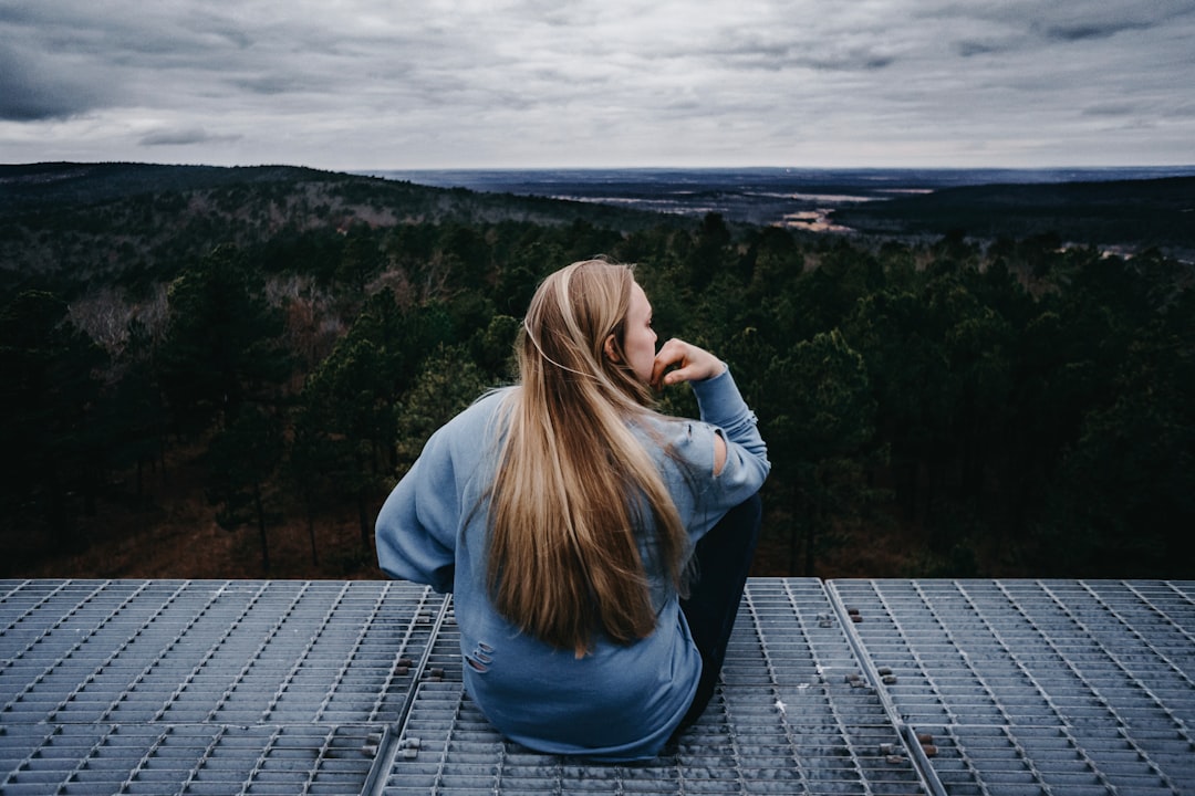 woman sitting on viewing deck