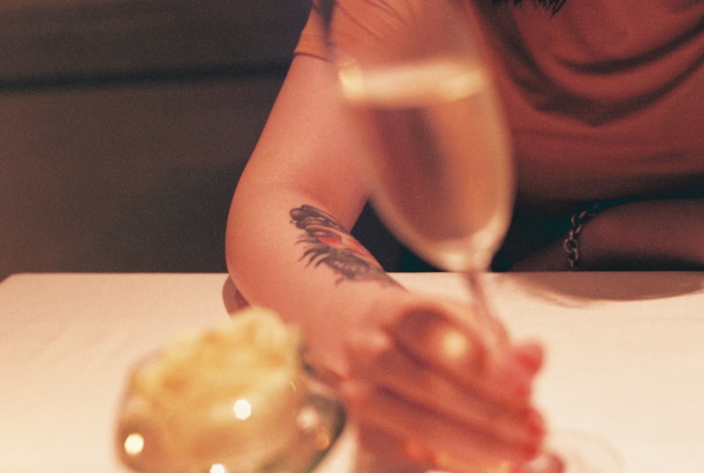 shallow focus photo of person holding champagne glass