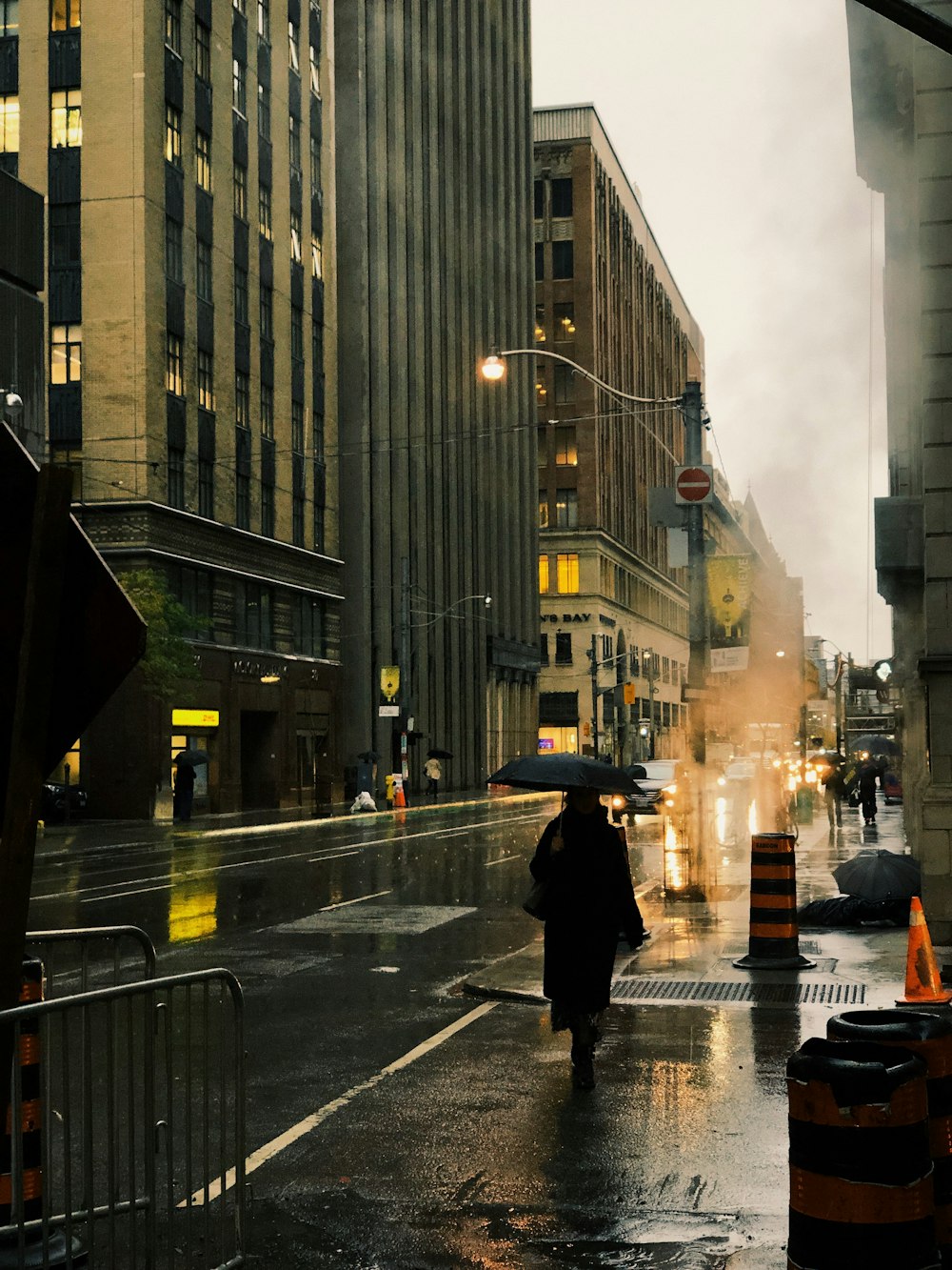 woman holding black umbrella