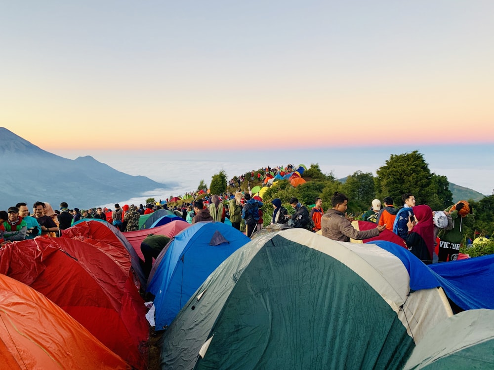 crowd standing beside set-up tents