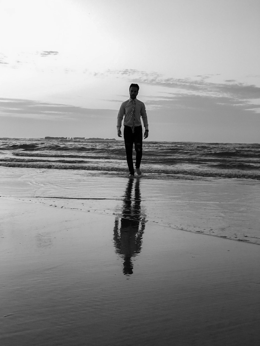 man walking on the seashore