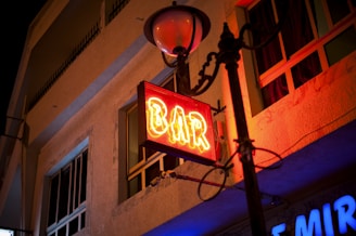 turned-on red Bar neon sign at night