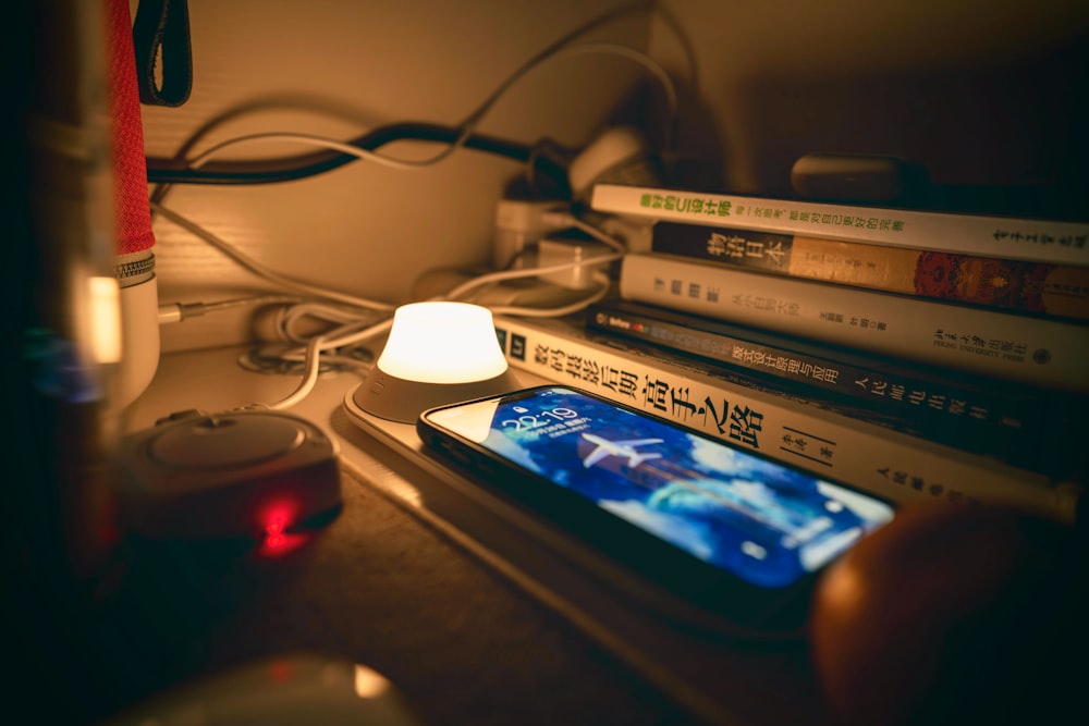 black smartphone beside a lamp