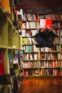 man floating while reading a book