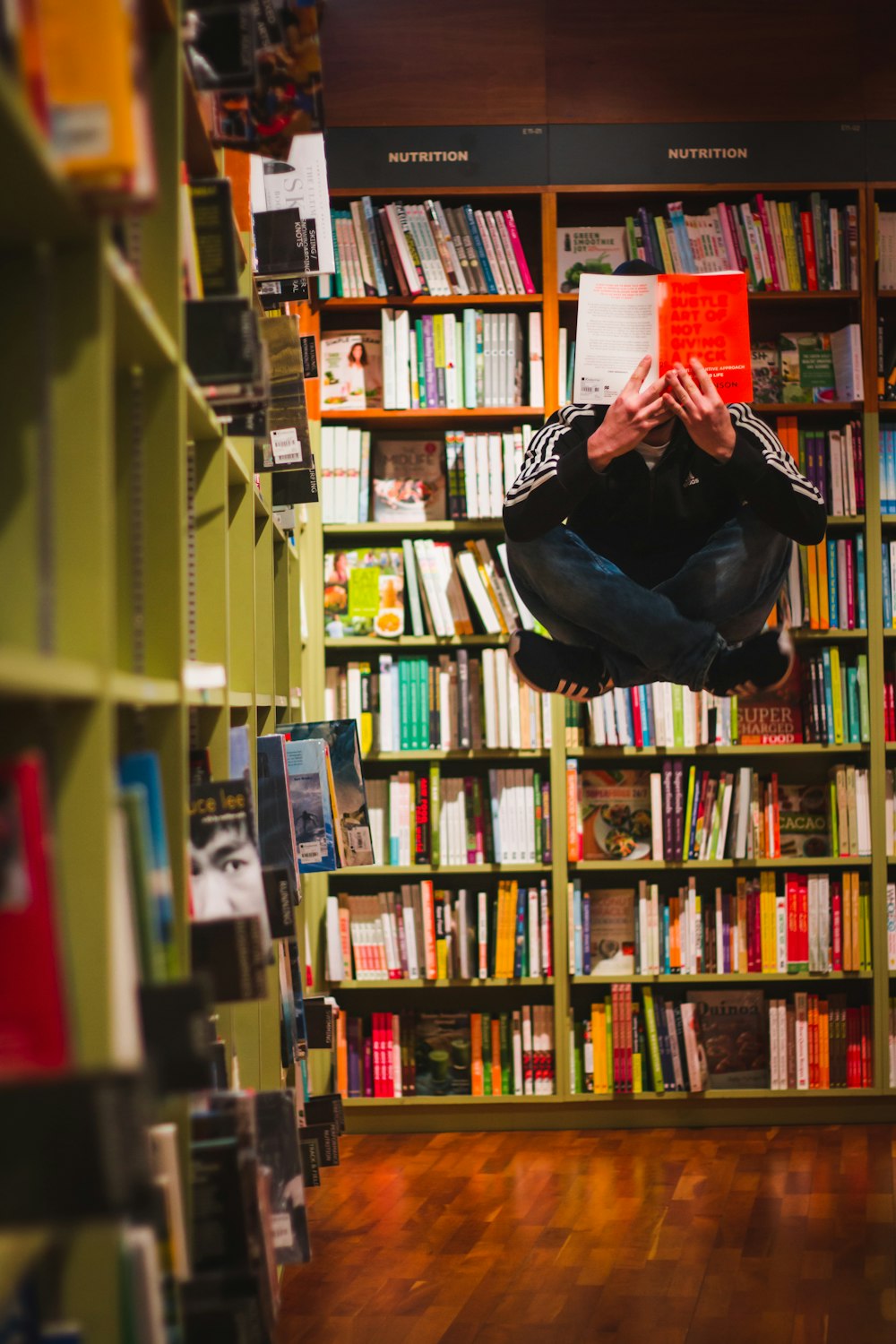 man floating while reading a book