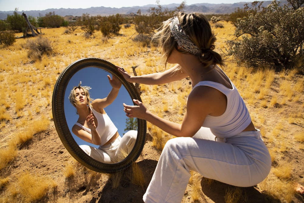 woman in white with a mirror