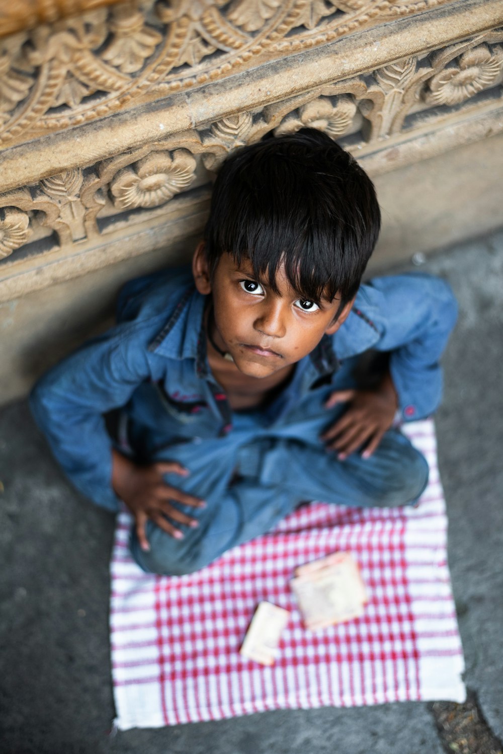 boy sitting and leaning while looking up