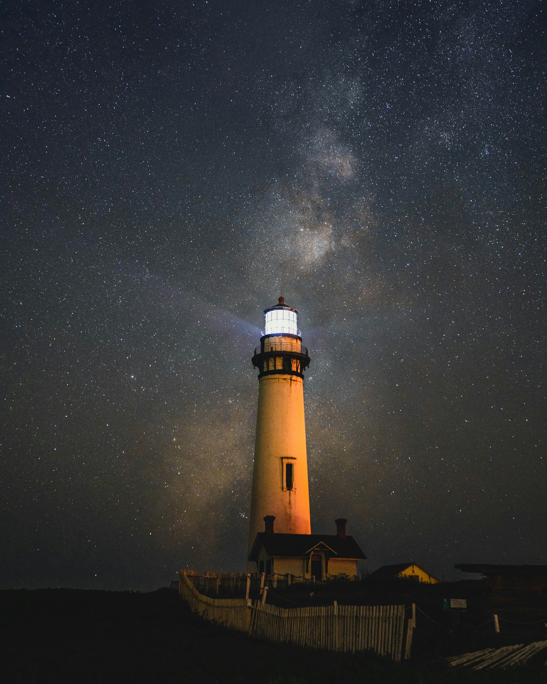 lighted white concrete lighthouse
