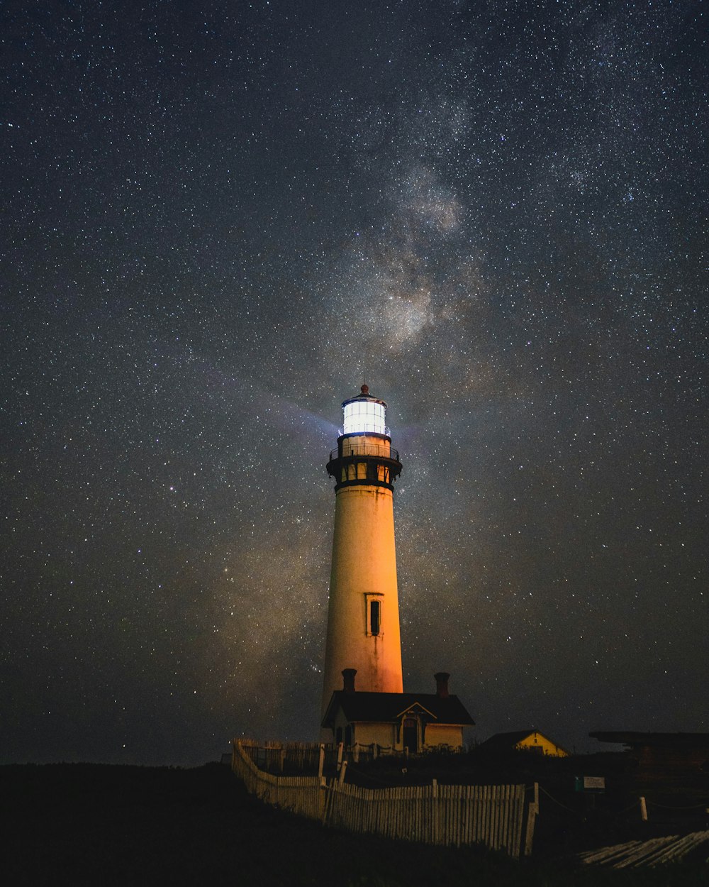 lighted white concrete lighthouse