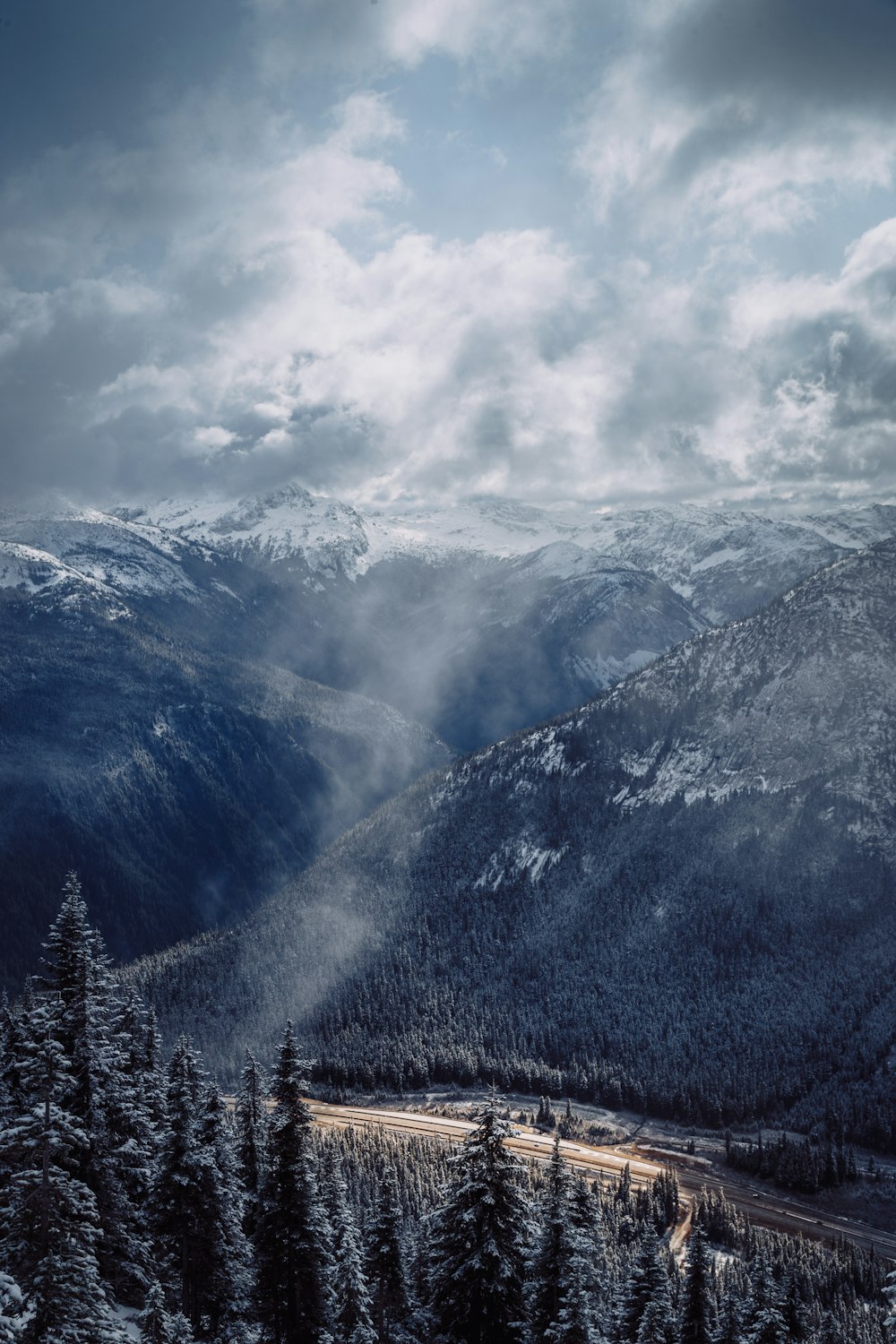 white clouds over mountain ranges