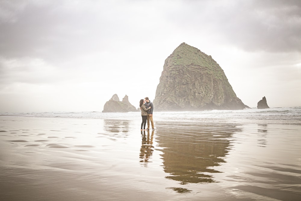 man and woman standing on shore