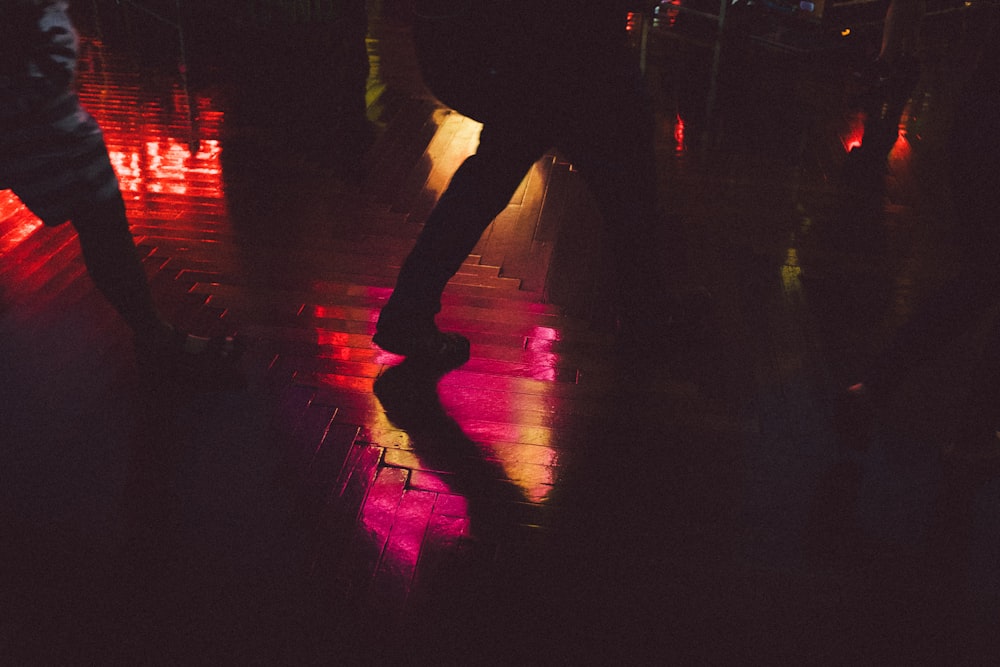 people walking on brown wooden tiles