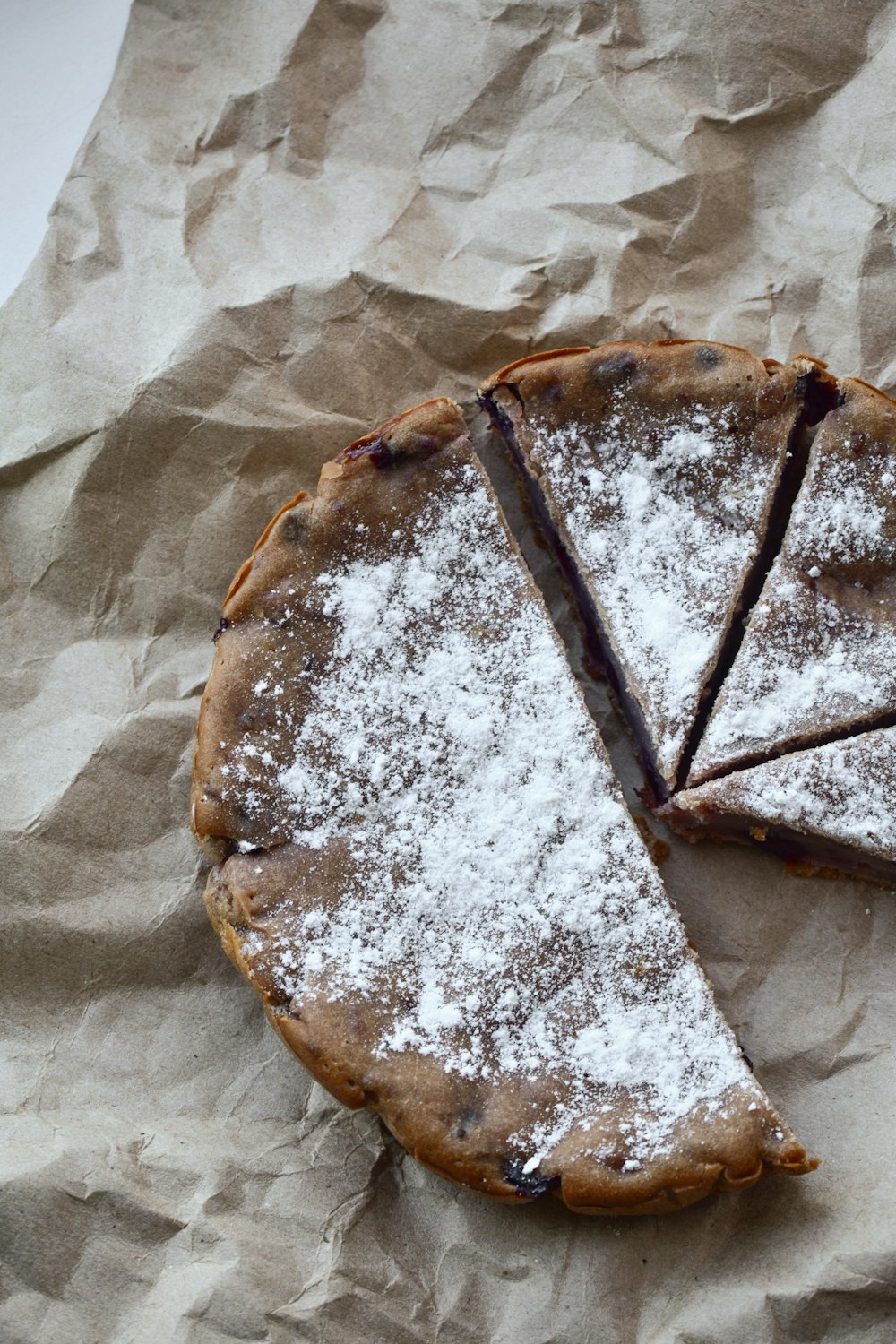 pie with slices on brown paper