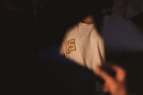Close-up of a black t-shirt with an embedded NFC chip glowing subtly.
