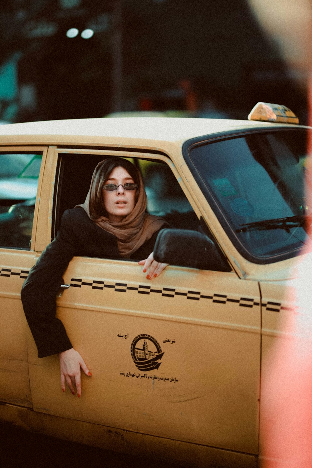 woman in brown scarf in taxi