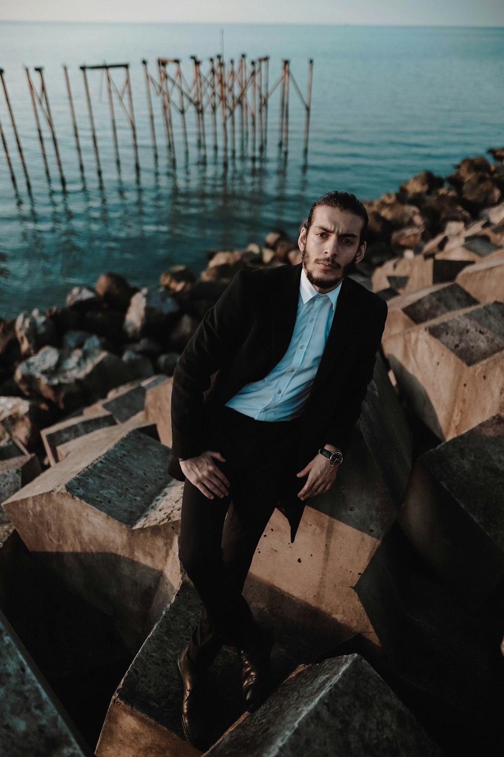 man sitting near body of water