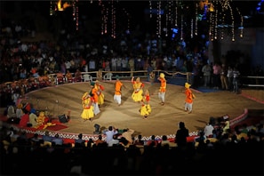 Traditional Basab dance performance with colorful costumes in an outdoor village setting
